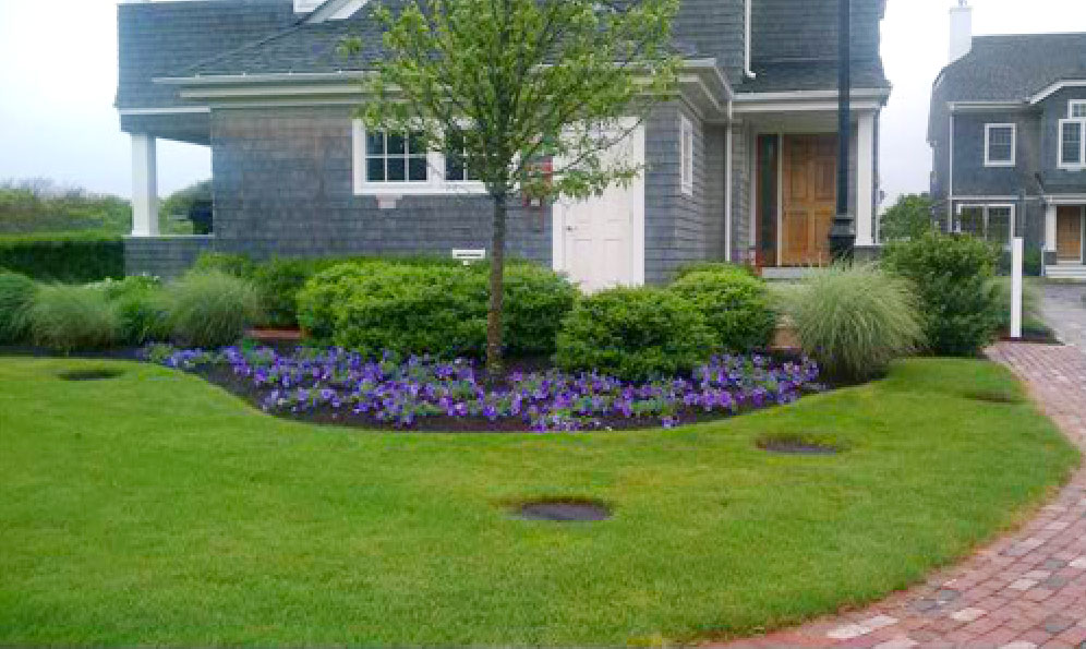 Licensed demonstration photograph of a landscaped Cape Cod home